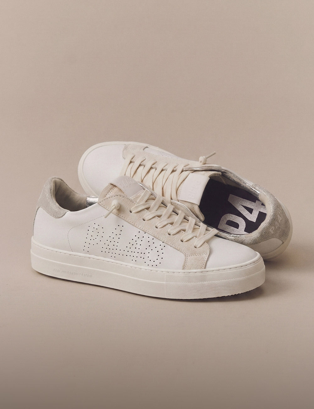 P448 women's sneaker in white leather with a perforated logo, beige suede details, and a metallic silver heel tab.