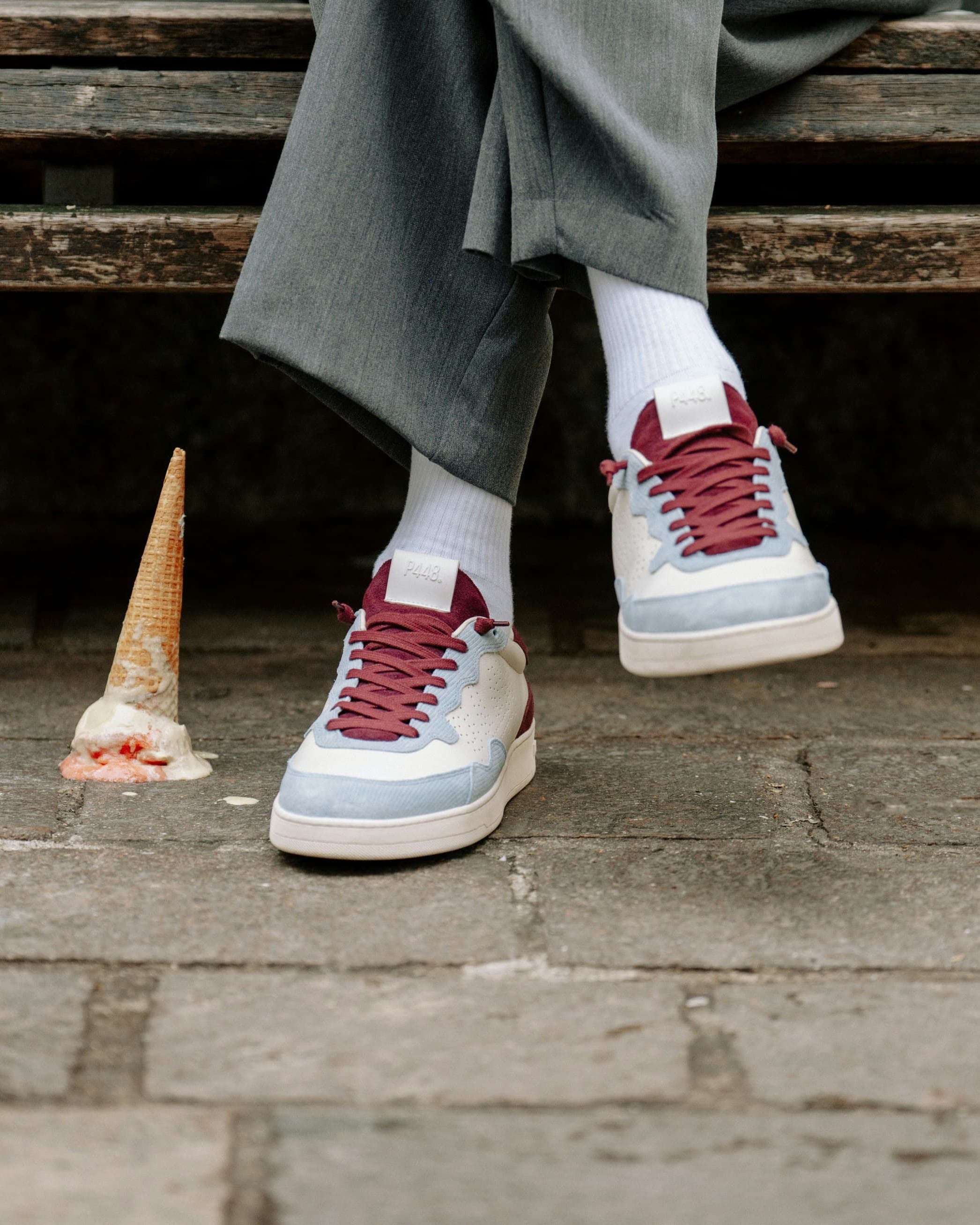 Side angle of beige and burgundy sneakers
