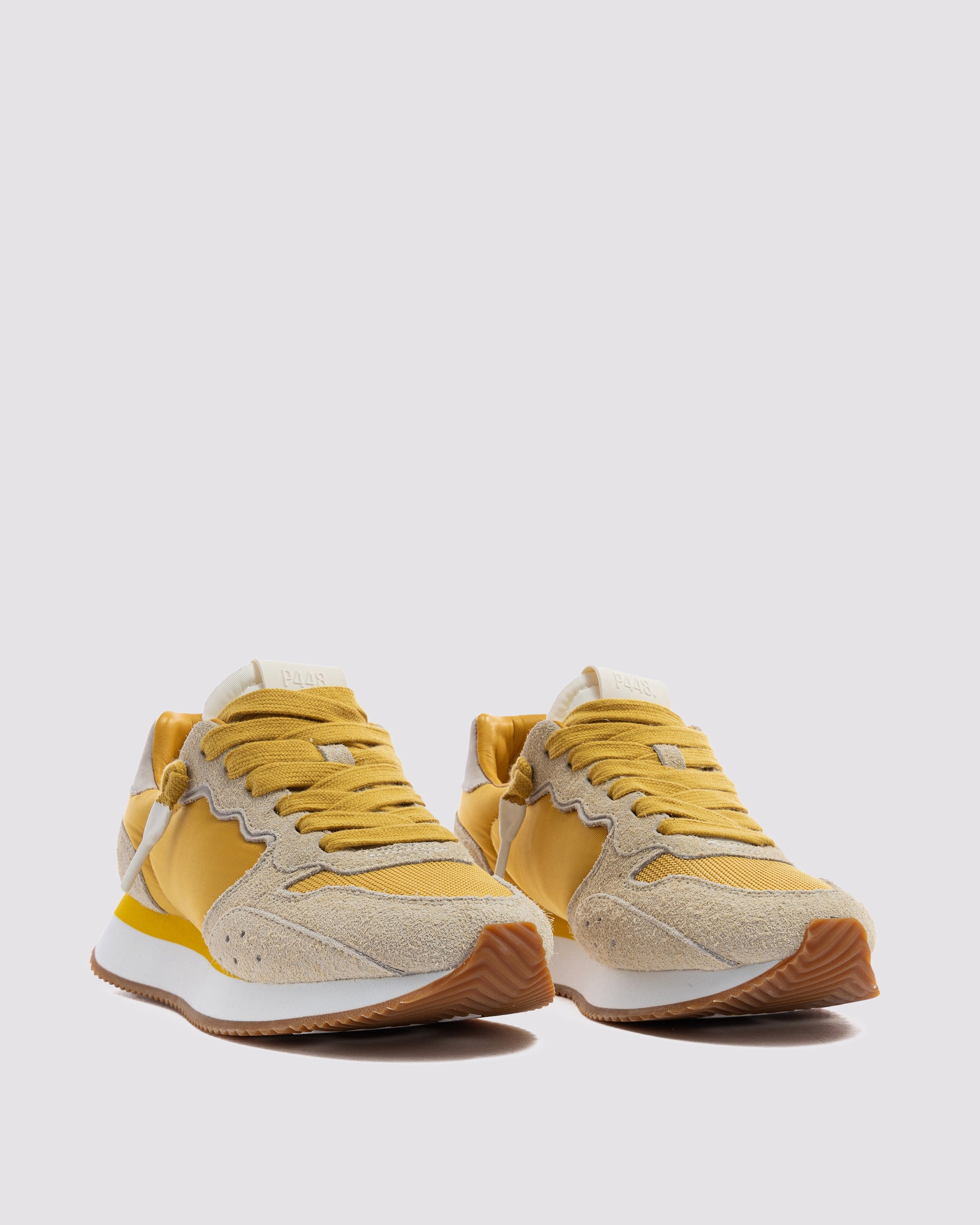 Side angle of mustard/white and yellow/grey sneakers