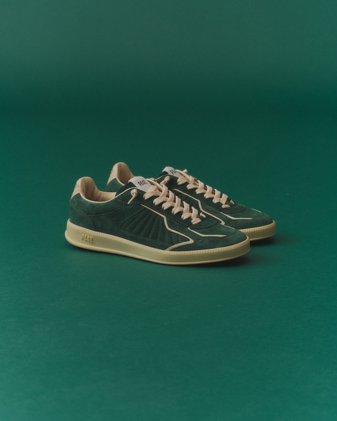 Side angle of green and white sneakers